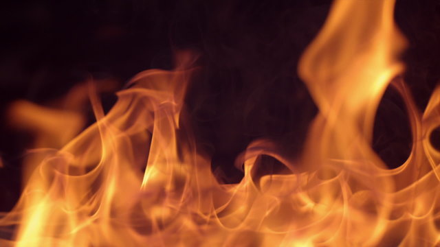 Closeup of fire burning on black background in slow motion