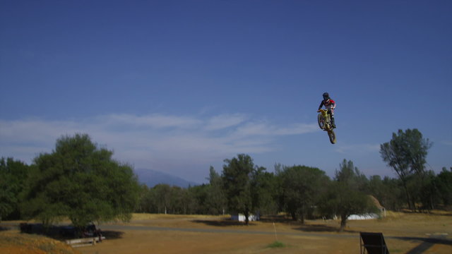 Motocross rider going off big jump, slow motion