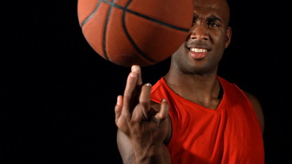 Basketball player spins ball on finger - Powered by Adobe