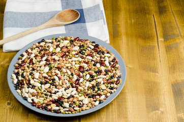 legumes in a dish on wood, close up, background