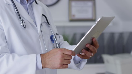 Closeup of doctor using digital tablet - Powered by Adobe