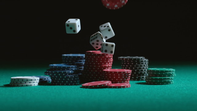 Dice and poker chips falling in slow motion