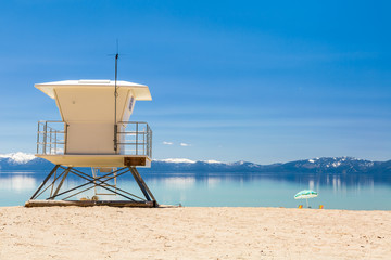 Beach patrol station on the lake with view on snowy Sierra Nevada mountains.