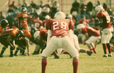 american football game with out of focus players in the backgrou