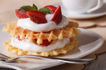 Belgian waffles with fresh strawberries and cream close-up 