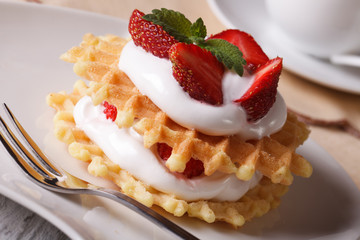 Waffles with fresh strawberry and cream close-up horizontal
