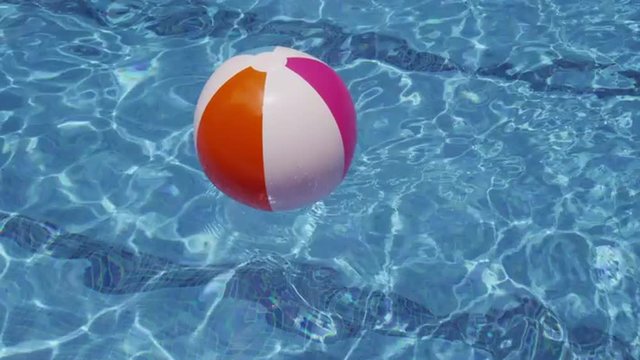 Beach ball floating in pool