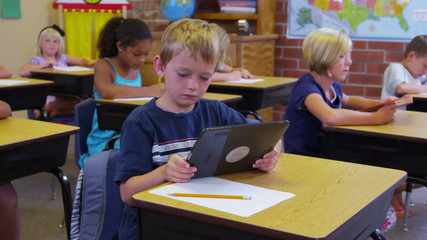Elementary school student uses a digital tablet - Powered by Adobe