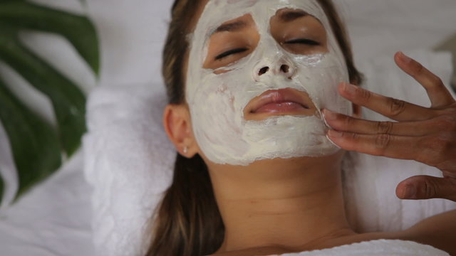 Woman at spa getting facial treatment