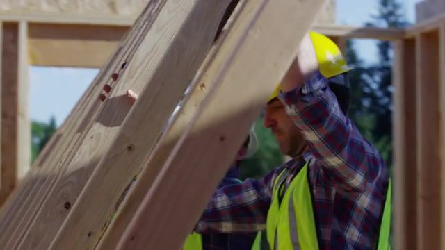 Group of construction workers standing up wall