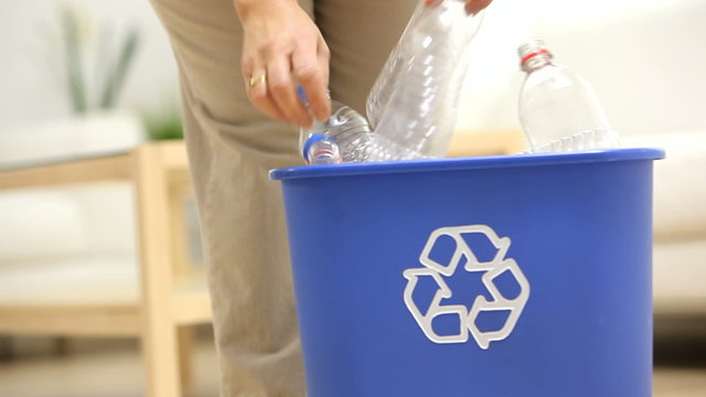Putting plastic bottles in recycle bin