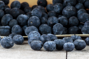 Blueberries in wooden box on wooden table