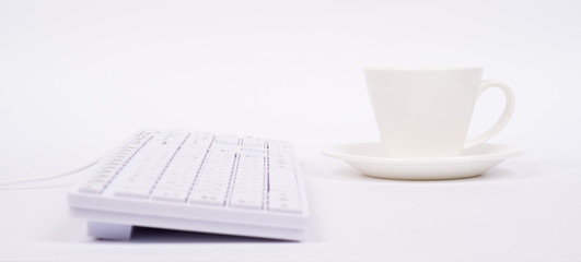 Computer keyboard and cup