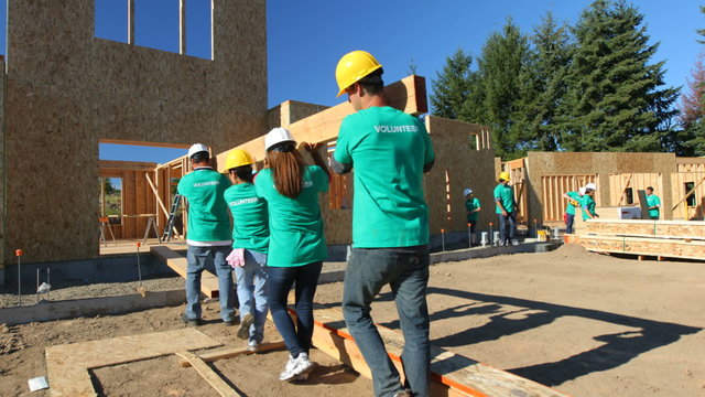 Volunteers working together on construction project