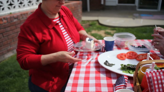 Passing cake at 4th of July party