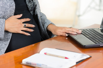 pregnant woman wearing casual clothes at work