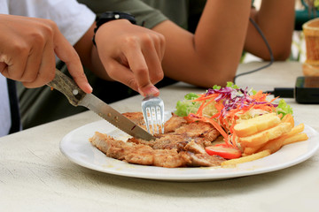 Pork chop, french fries with salad