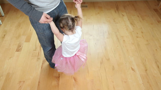 Father dancing with young girl