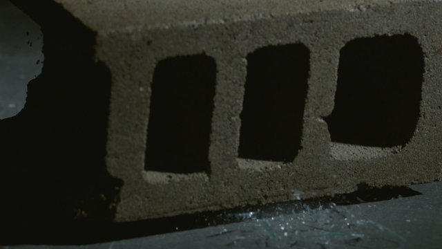 Clock is crushed by concrete block in slow motion