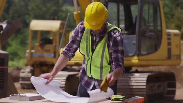 Construction worker looking over plans