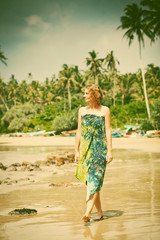 Woman walking on tropical beach - retro style photo