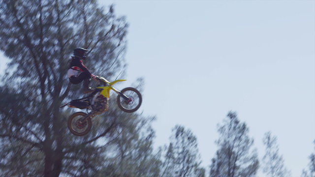 Motocross rider going off big jump, slow motion