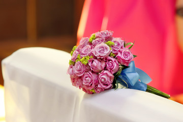 Wedding rose bouquet on hassock in church