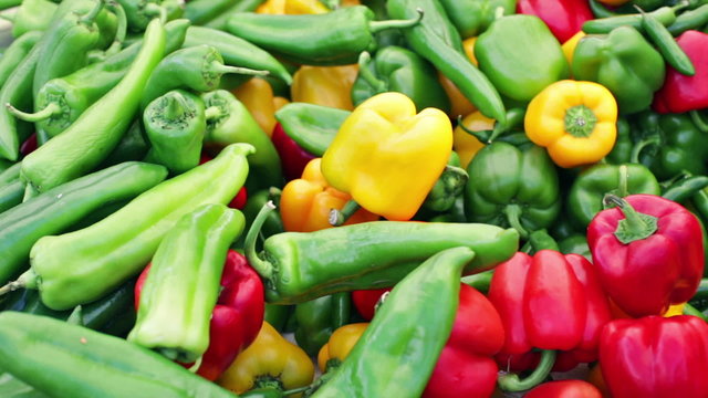 Variety of fresh organic peppers on the table at the local farmer's market.