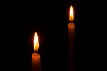  glowing candles on dark background.