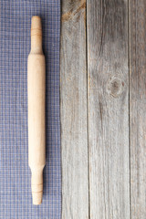 Empty wooden table with rolling pin and napkin on grey backgroun