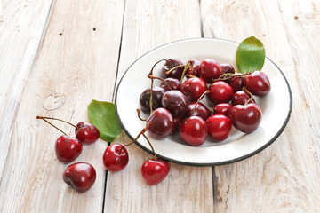 Sweet cherry on white plate and white background