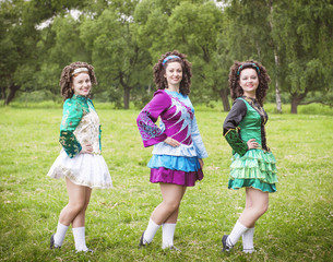 Fototapeta premium Three young beautiful girls in irish dance dress posing outdoor