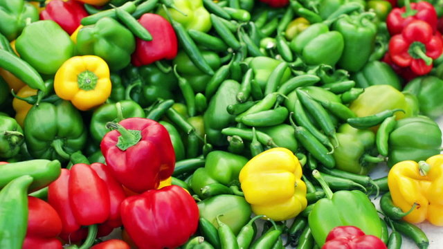 Variety of fresh organic peppers on the table at the local farmer's market.