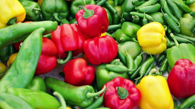 Variety of fresh organic peppers on the table at the local farmer's market.