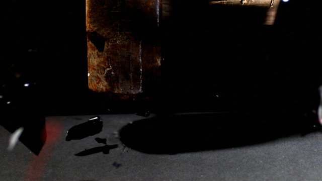 Sledge hammer smashing clock, slow motion