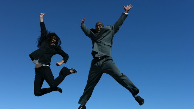 Businesspeople jumping in air celebrating, slow motion