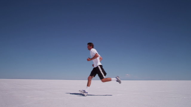 Athlete running at salt flats