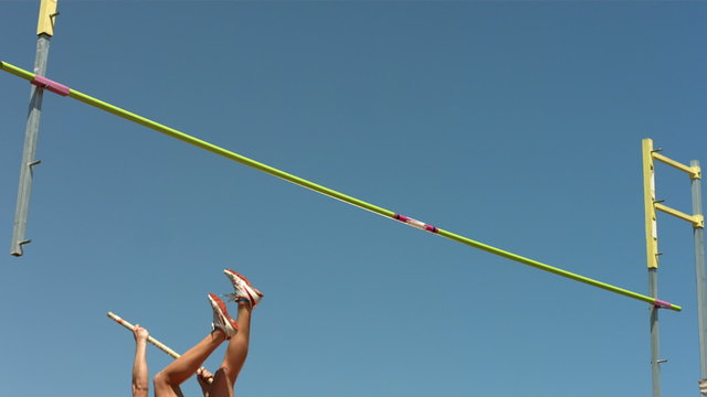 Track and Field athlete doing pole vault, slow motion