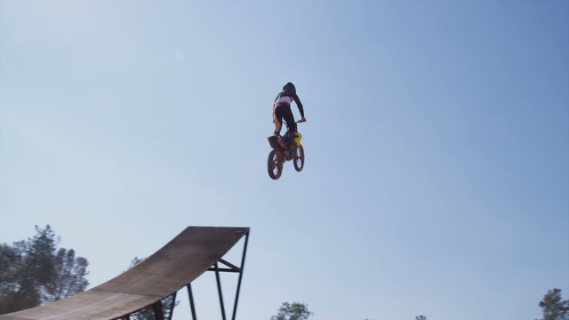 Motocross rider going off big jump, slow motion