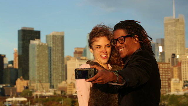 Couple talking self portrait in front of city skyline