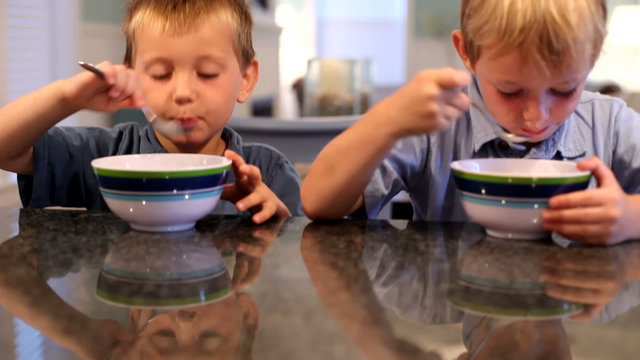 Two young boys eating ice cream