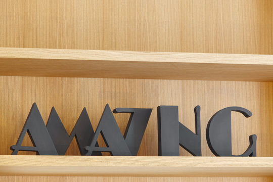 Amazing text in black color over a wooden bookshelf