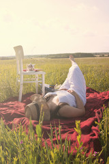 Woman Laying Down on Meadow on Picnic Cloth