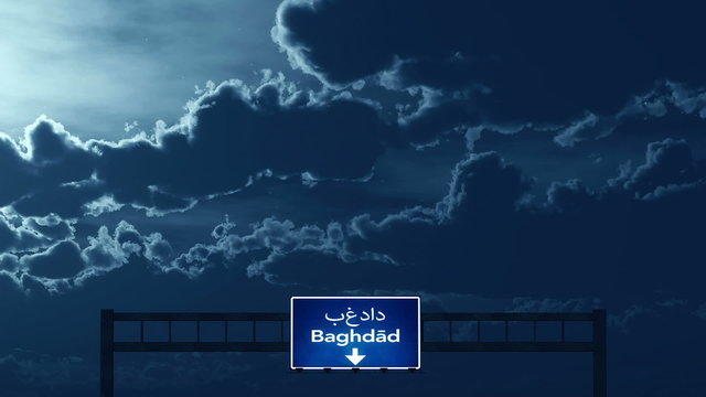 Passing under Baghdad Iraq Highway Road Sign at Night
  