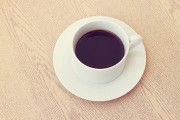Vintage style of a cup of coffee on cute fabric.