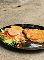 Steaks, french fries with vegetables salad on a plate