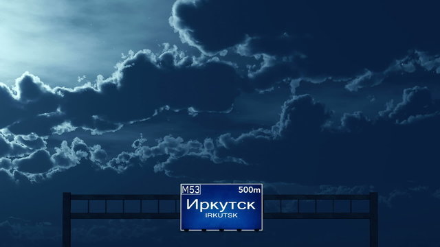 Passing under Irkutsk Russia Highway Road Sign at Night
  