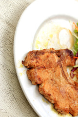 Pork chop, french fries with salad