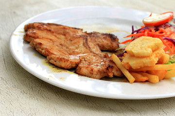 Pork chop, french fries with salad