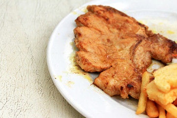 Pork chop, french fries with salad